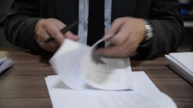 Öğretmen sınıf öğrencilerinin sınav kağıtlarını kontrol ediyor.