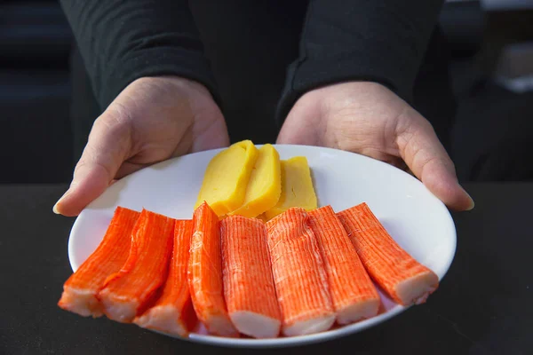 chef is preparing crab sticks and  tamagoyagi for making japan cookery menu, japanese maki sushi roll serving in oriental restaurant, various different assorted luxury mixed healthy eating set concept