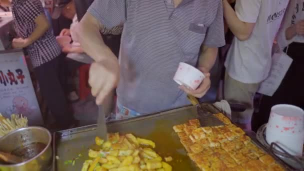 2021年6月15日 在中国拥挤的十字路口附近烹调街头食品的亚洲人 亚洲街头食品 亚洲夜市 中国食品 臭豆腐 烤豆腐 中国传统食品 — 图库视频影像