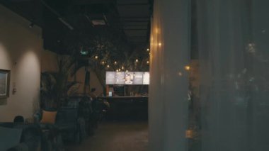 Blond hair girl walking in the restaurant, cozy interior design 4K footage