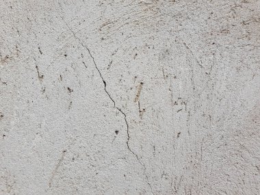 Kabataslak yüzeyli, arka plan desenli boyanmamış alçı bir duvara yaklaş