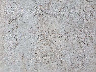 Kabataslak yüzeyli, arka plan desenli boyanmamış alçı bir duvara yaklaş