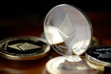 Maesot, Tayland... 13 Haziran 2021: ahşap bir masaya istiflenmiş Ethereum sikkeleri. Şifreleme para sanal para kavramını kabul et.