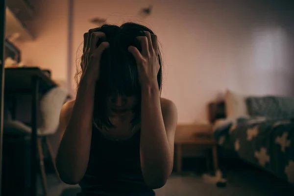 Depressed Woman Clutching Her Forehead Dimly Lit Bedroom — Stock Photo, Image