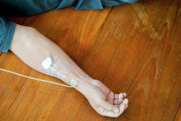 Arm of a male patient who was injecting saline solution into veins.