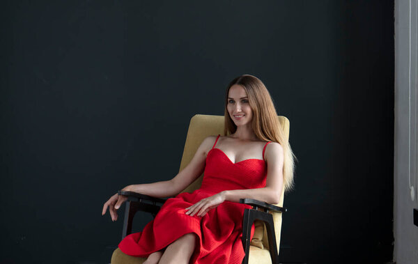 Portrait Beautiful Young Woman Sitting Chair Red Dress Dark Background Stock Picture
