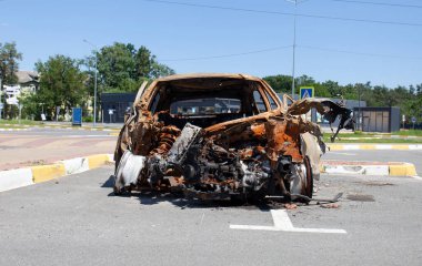 remains of a car destroyed as a result of hostilities in the Kyiv region