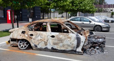 remains of a car destroyed as a result of hostilities in the Kyiv region