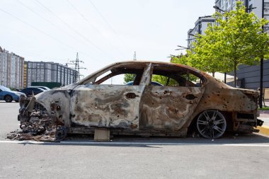 remains of a car destroyed as a result of hostilities in the Kyiv region