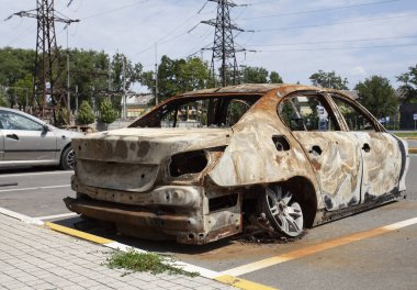 remains of a car destroyed as a result of hostilities in the Kyiv region