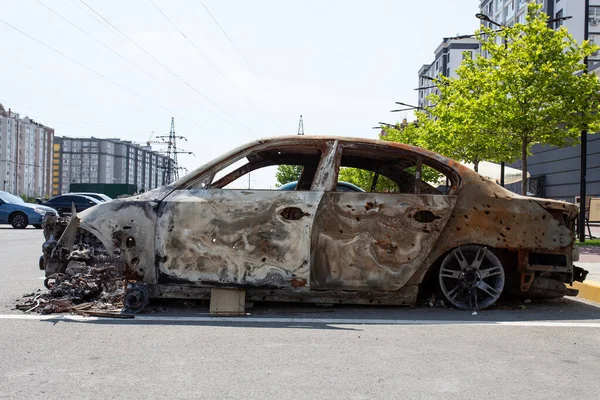 remains of a car destroyed as a result of hostilities in the Kyiv region