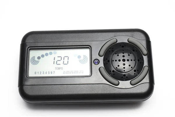 Close up of black modern digital metronome for beat setting while playing music on white background