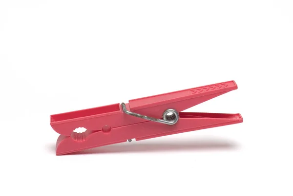 Close Red Plastic Clothespin Metal Spring White Background — Zdjęcie stockowe