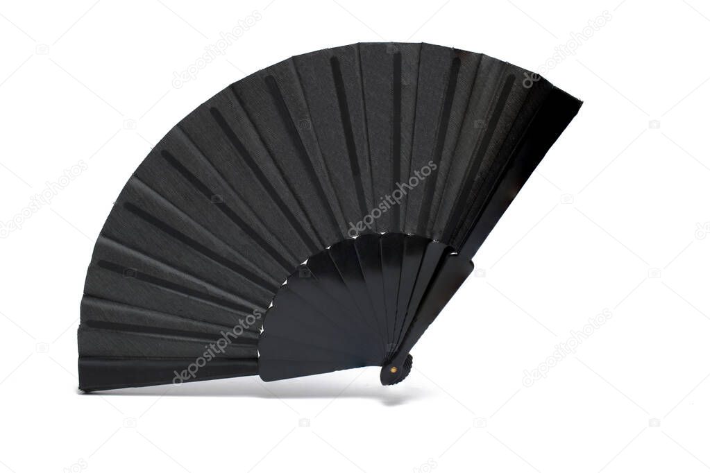 Close up of completely opened black classic fan to fan cool air on hot days on white background Spanish culture and mourning concept