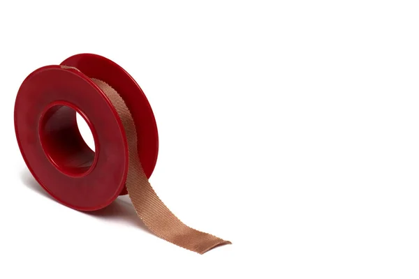 Close Red Plastic Roll Plaster Tissue Adhesive Tape Fixing Wound — Stock Photo, Image
