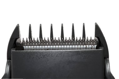 Close up of the front of an electric beard trimmer hair clipper with scraper mounted in front of blades on white background