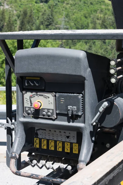 Close-up of mobile crane control of truck with clearly visible emergency exit power off buttons and levers for operation