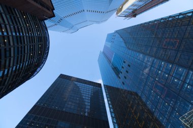 View to the sky between high-rise buildings skyscrapers as a concept for business banks wall street and stock market