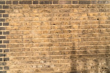 Detail of brick wall built with yellow bricks well visible texture and joints to use as background