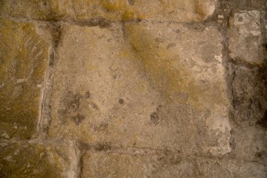Close up of worn smoothed stone floor of an ancient Roman road or sidewalk pavement as a concept for ancient paths
