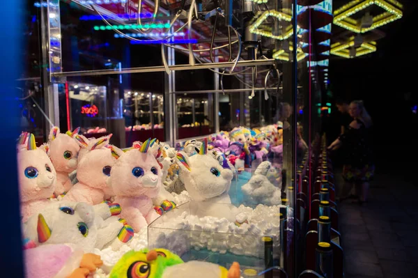 Claw machine Toy Arcade game filled with unicorns childrens toys — Stock Photo, Image