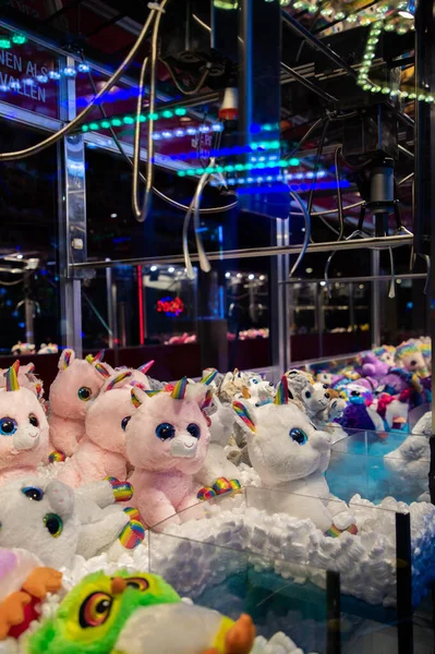 Claw machine Toy Arcade game filled with unicorns childrens toys — Stock Photo, Image