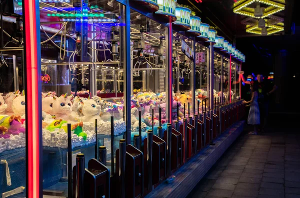 Claw machine Toy Arcade game filled with unicorns childrens toys — Stock Photo, Image