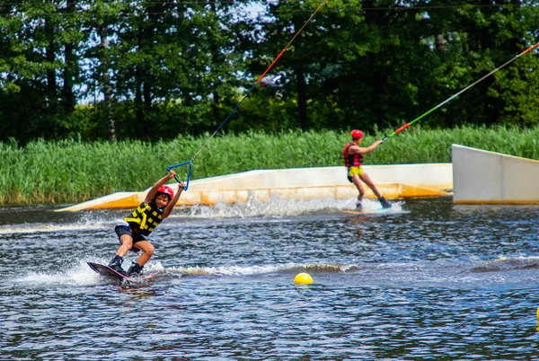 Boy age 9 riding wakeboard on lake — Stock Photo, Image