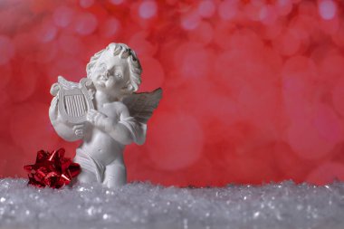 Seramik melek heykeli ve kar üzerinde duran Noel dekoru 