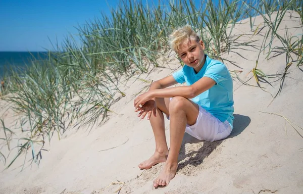 Teenager boy on summer vocation at the beach