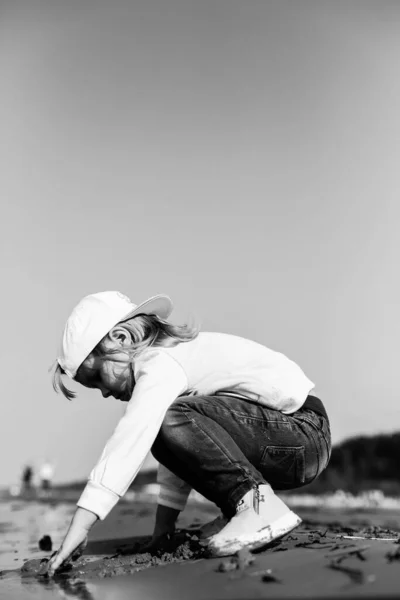 Happy toddler child playing on the beach