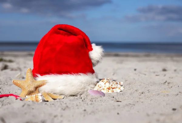 Sfondo Natalizio Cappello Babbo Natale Stelle Marine Sulla Spiaggia Sabbiosa — Foto Stock