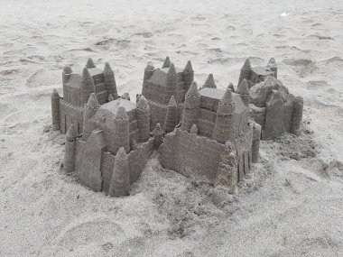 Child made sandcastles on the beach. High quality photo