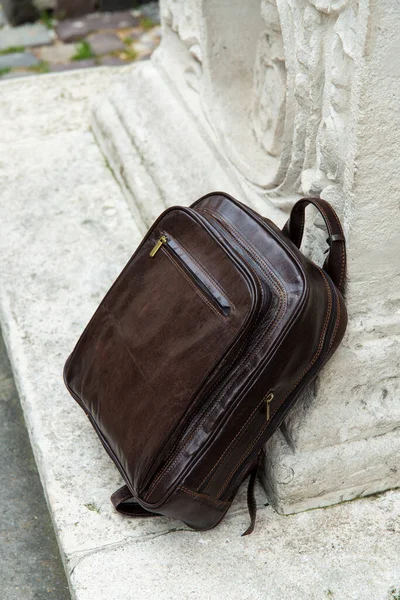 Brown leather backpack on the snone monument