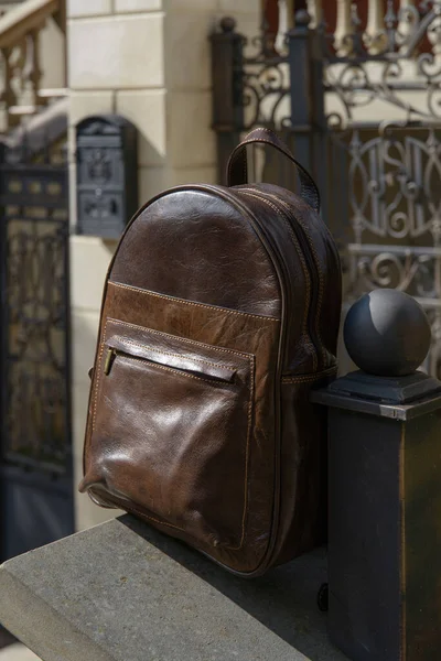 Brown leather backpack on the snone monument — Stock Photo, Image