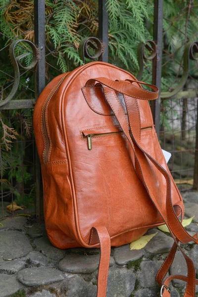 Orange leather backpack on the snone monument — Stock Photo, Image