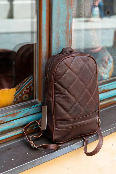 Brown leather backpack on the windowsill — Stock Photo, Image