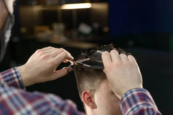 Close-up of hairdresser male hands during cutting male hair — Zdjęcie stockowe