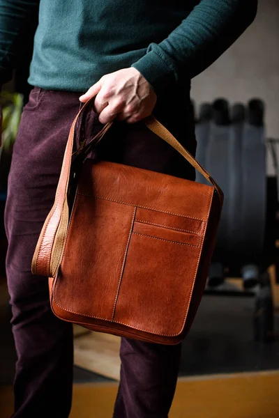 Close-up photo of orange leather bag in mans hand — Stock Photo, Image