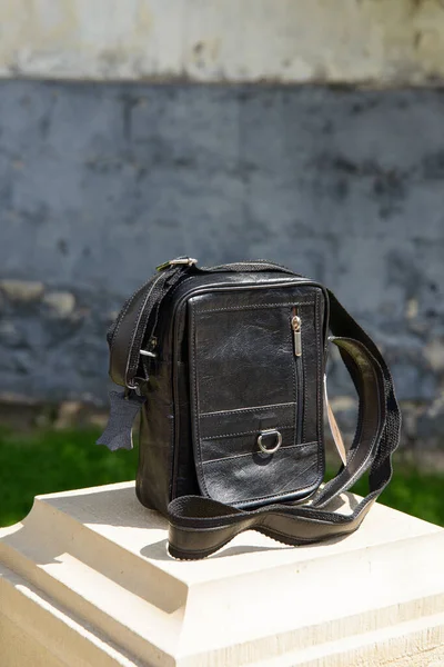 Outdoor photo of a dark brown leather Messenger bag. — Stock Photo, Image