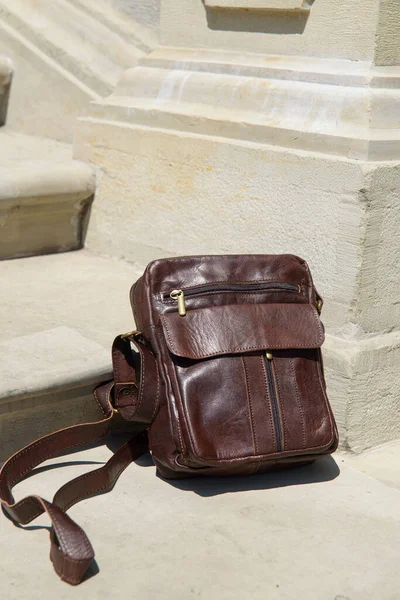 Outdoor photo of a brown leather Messenger bag. — Stock Photo, Image