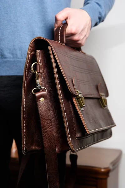 Man holding brown leather briefcase with two locks. hotel room photo — Stock Photo, Image