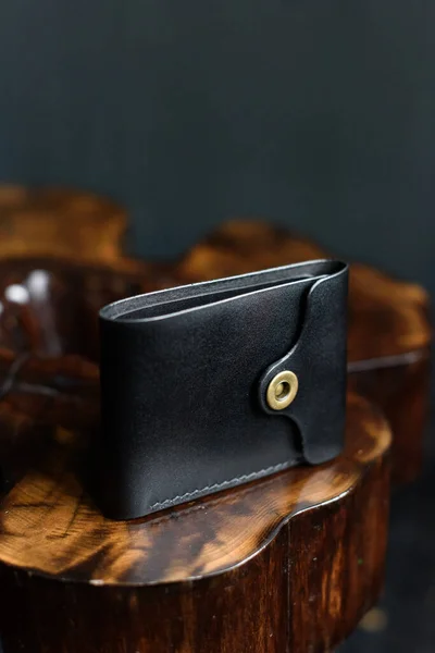 Hand made black leather wallet on a wood . Leather craft. Selective focus — Stock Photo, Image