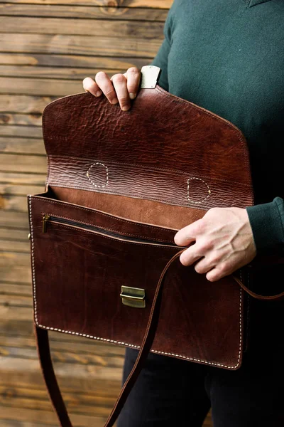 Close-up photo of brown leather bag in mans hands — Stock Photo, Image