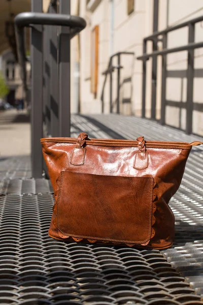 Close-up photo of orange leather bag on a metal texture background — Stock Photo, Image