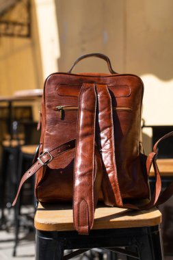 Orange leather backpack. Street photo. Natural light