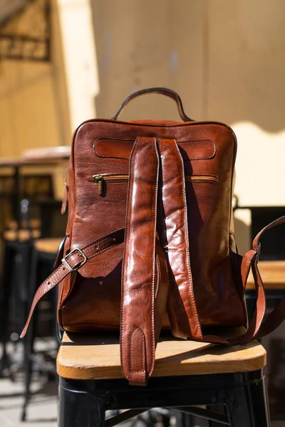 Orange leather backpack. Street photo. Natural light — стоковое фото