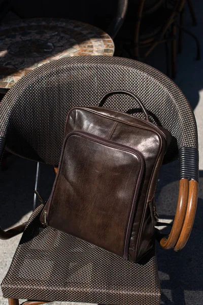 Brown leather backpack on the stylish chair — Stock Photo, Image