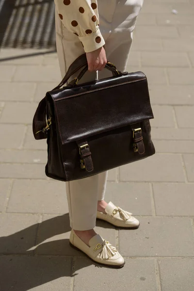 Part photo of a woman with a brown leather briefcase with antique and retro look. Outdoors photo — Foto de Stock
