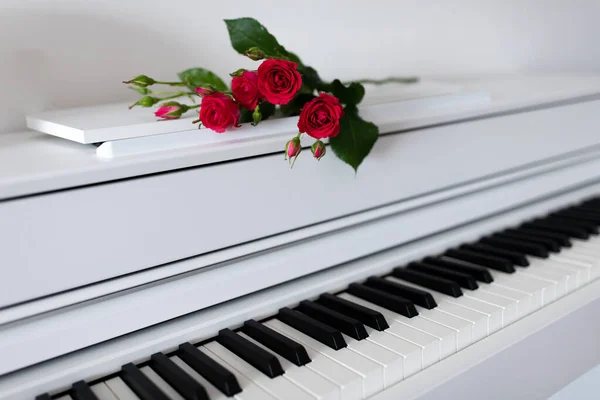Ein Blumenstrauß liegt mit geöffneten Tasten auf dem Klavier. — Stockfoto